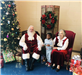 Mr. and Mrs. Santa with a child