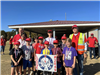 Adults and children holding an Elks Lodge sign. 