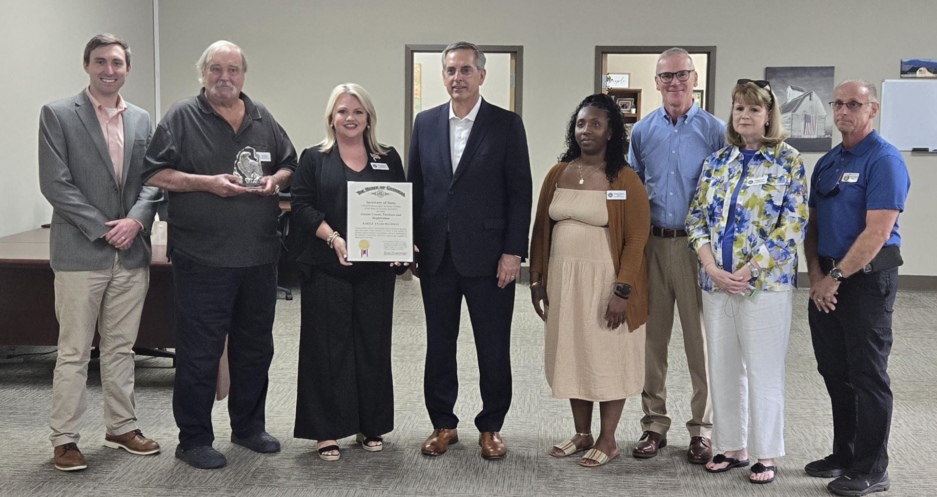 Five men and three ladies receiving an award